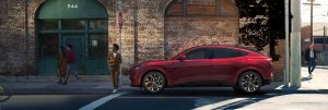 A red 2021 Ford Mustang Mach-E parked on a street in Waco, TX